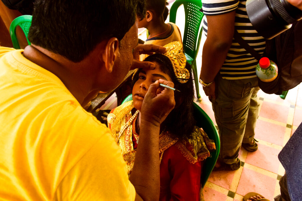 A girl being dressed as Lady Radha