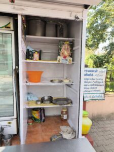 Left side of the metal box which has racks to store dress materials-and other items to be distributed among the poor